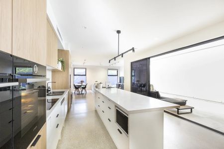 Stylish modern home featuring five bedrooms across two levels - Photo 4