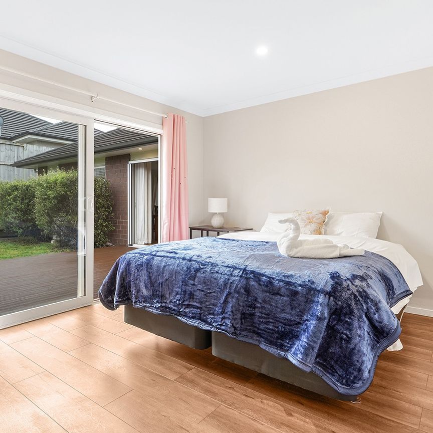 Modern four-bedroom home for rent in the popular Flagstaff area, featuring a master bedroom with a stylish ensuite, a modern kitchen with gas cooking and a pantry for extra storage, two spacious living areas with a cozy fireplace, a contemporary bathroom, and a double internal-access garage. - Photo 1