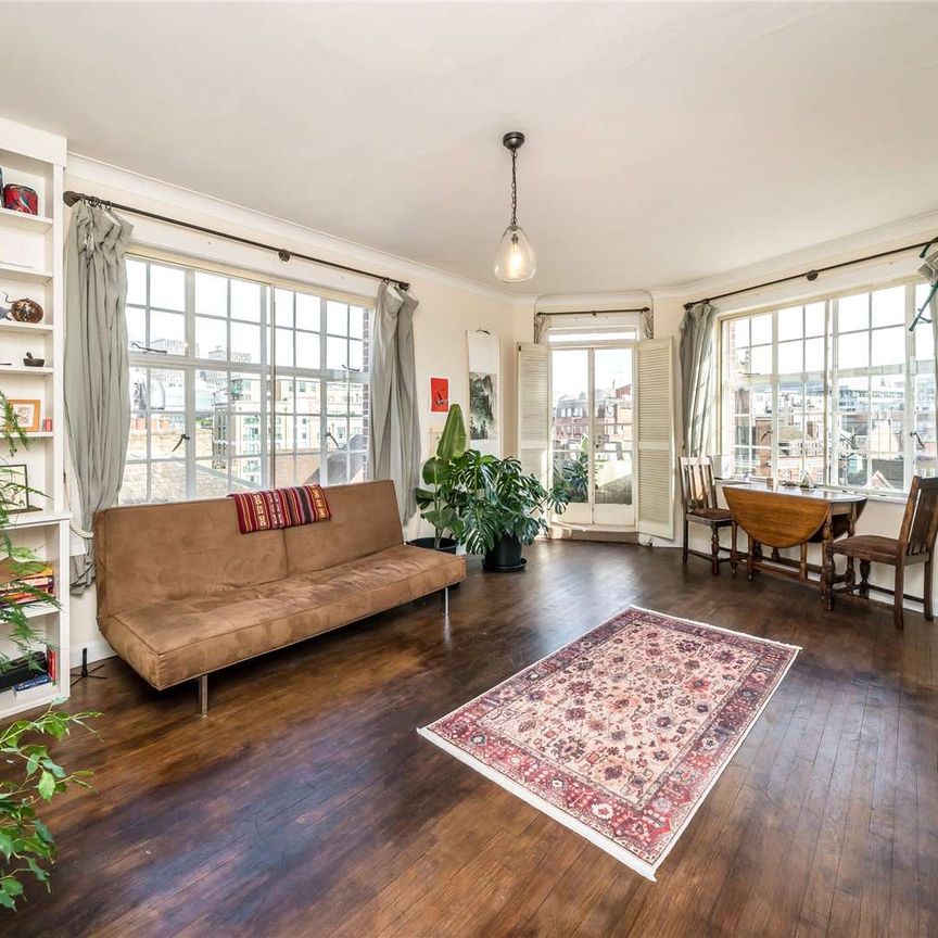 Charming and spacious 1-bedroom top floor property with tremendous natural light and wonderful views towards some of London's most iconic landmarks. - Photo 1