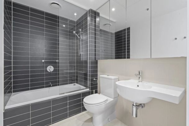 FULLY FURNISHED Light-Filled Top-Floor Retreat with Premium Amenities - Photo 1