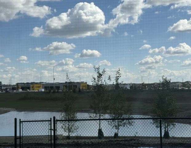 Brand new Estate home backing onto Pond; close to 14Street NW/ Stoney Trail NW. — 5 Bedrooms+ Den House - Photo 1