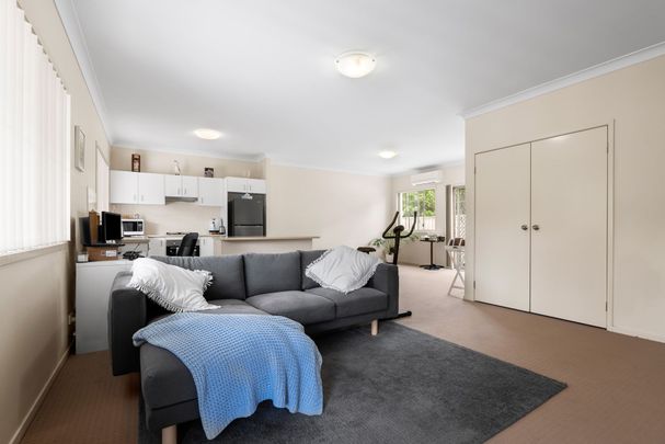 Nestled in a peaceful complex, this delightful two-bedroom unit offers comfort and convenience - Photo 1