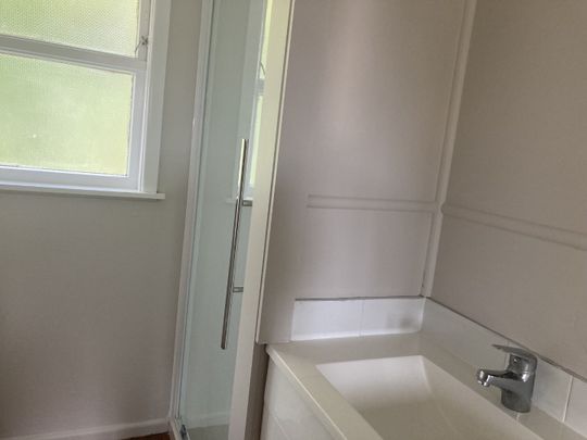 This generous two-bedroom unit offers an open-plan living area, two sizable bedrooms, off-street parking, and a carport. - Photo 1