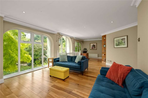 A spectacular three-bedroom home set within a private gated development, combining elegant period features with a dramatic double-height living space and south-facing garden. - Photo 1