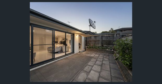 Charming two-storey home with modern amenities and versatile living space - Photo 1