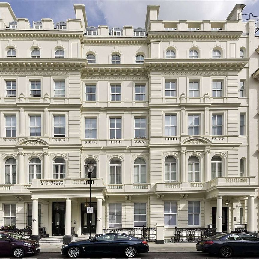 An impressive two bedroom duplex flat occupying the raised ground and lower ground floors of a Victorian house on Lancaster Gate. - Photo 1