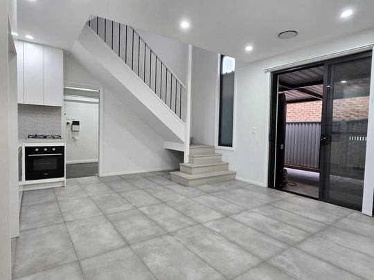 Near New Three-Bedroom Townhouse in a Prime Location! - Photo 1