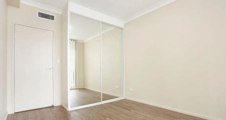 Three-bedroom apartment with laminated timber flooring throughout. - Photo 2
