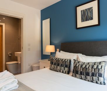 A fully furnished, one-bedroom apartment with a private balcony and... - Photo 4