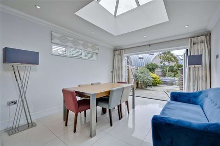 A beautifully presented four-bedroom property with off street parking and a private landscaped garden in a most popular Surrey village. - Photo 2
