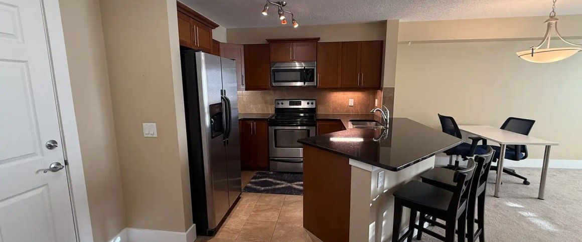 Top-Floor 1 Bed + Den | Rocky Ridge Ranch Access | Heated Parking | Walk to LRT — 1 Bedroom+ Den Condo Unit - Photo 1
