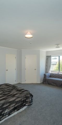 This furnished studio unit includes an ensuite bathroom and a small kitchenette. - Photo 1