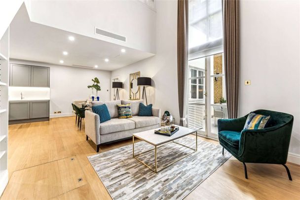 A bright duplex apartment benefiting from double height ceilings in the reception with French doors leading onto a private courtyard. - Photo 1