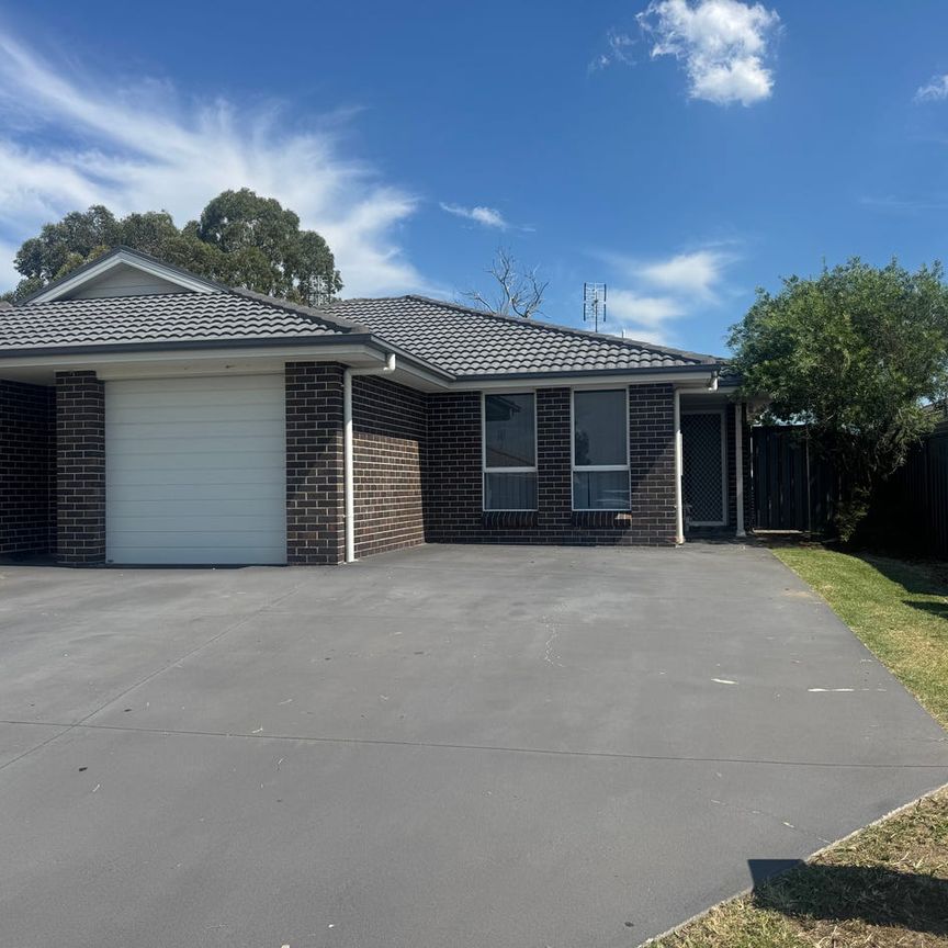 This immaculate two-bedroom unit is ideally located close to the Hunter Expressway, offering comfort and convenience. - Photo 2