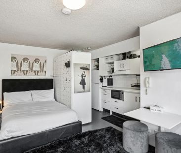 Updated Convenient Studio with Rooftop Pool | Furnished - Photo 1