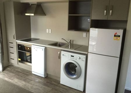 Furnished studio room featuring essential amenities such as a bed, TV, bar fridge, microwave, and heat pump. - Photo 2