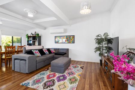 Step inside to discover a blend of modern comfort and timeless charm, featuring polished wooden floorboards and a split system in the spacious lounge area. The large open-plan lounge and dining space - Photo 2