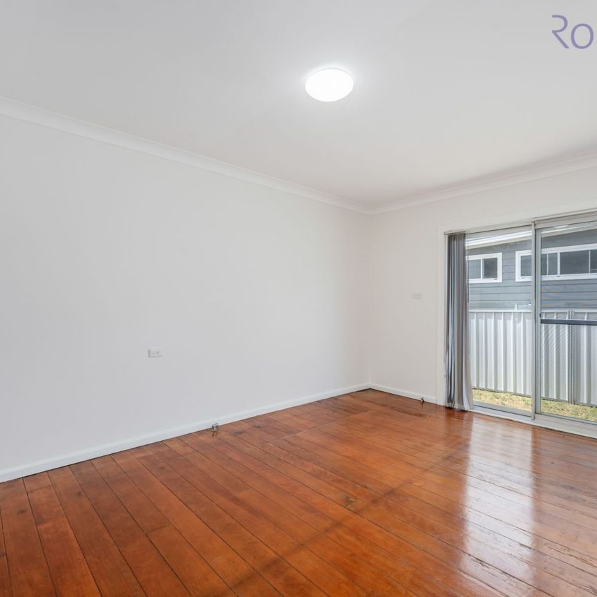 Freshly painted three bedroom home with air-conditioned living space and off street parking. - Photo 1