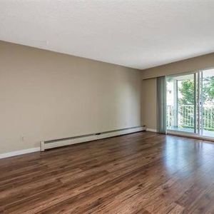 Spacious 2 Bedroom Top Floor Corner Condo with own Parking - Photo 2