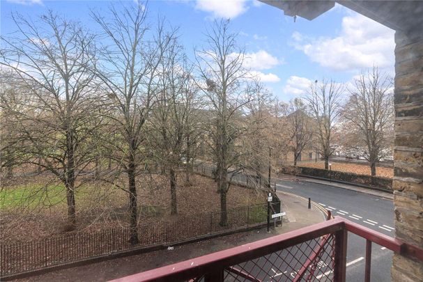 This property benefits from a bright and spacious reception room with exposed brickwork and wooden flooring. - Photo 1