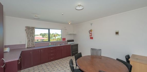 This furnished studio unit includes an ensuite bathroom and a small kitchenette. - Photo 2