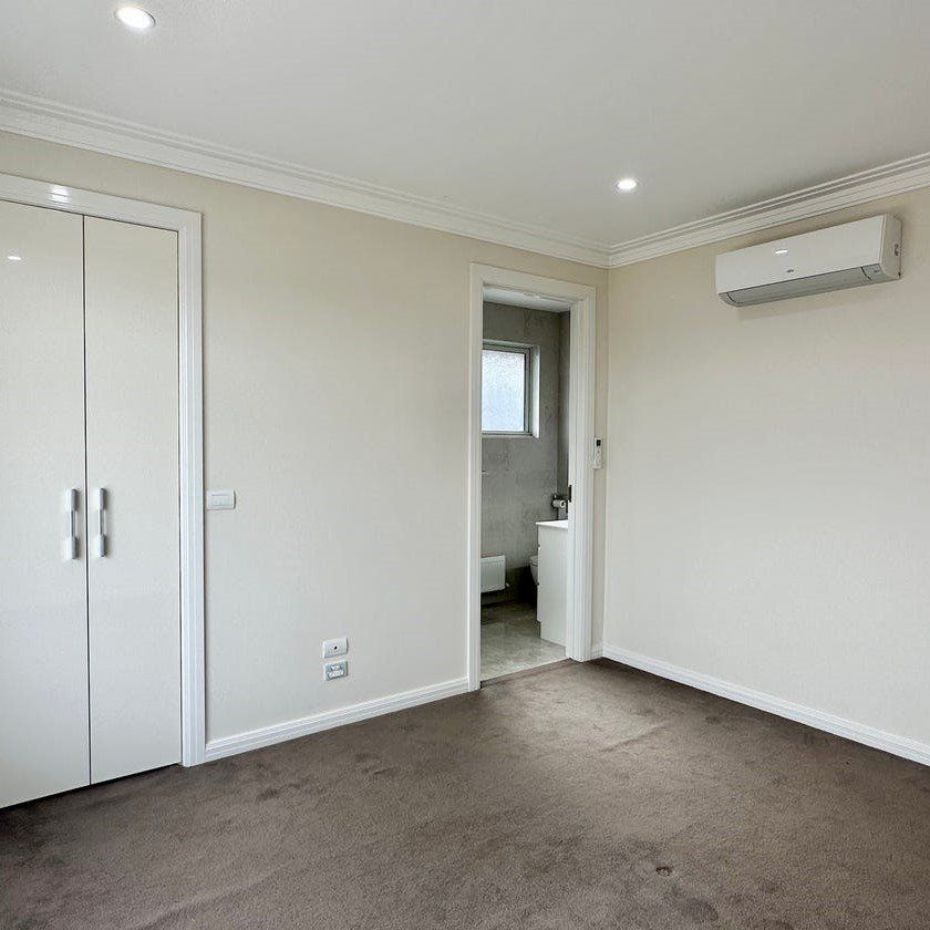ARCHITECTURALLY DESIGNED TOWNHOUSE IN THE MCKINNON SCHOOL ZONE - Photo 1
