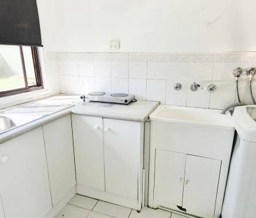 “1BR tiled Flat. New paint. AC. Rent incl. water. Walk to train & W... - Photo 1