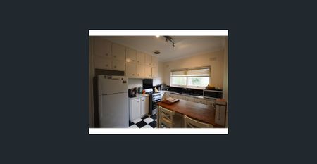 This secure residence offers low-maintenance living with a light-filled interior and practical design - Photo 4