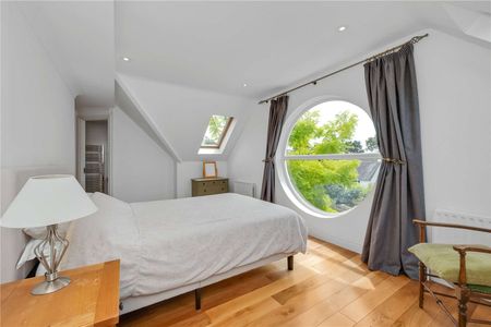 A spectacular three-bedroom home set within a private gated development, combining elegant period features with a dramatic double-height living space and south-facing garden. - Photo 4