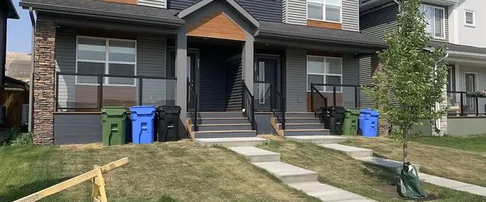 Duplex near walking and biking trails, dog park and golf course | 311 Wolf Creek Way Southeast, Calgary - Photo 1