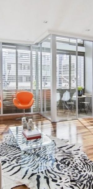 Sophisticated & Stylish Dual-Level Apartment in a Prime Location - Photo 1
