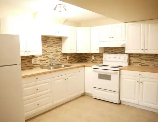 Large1200sf Renod 2BR Bsmt-INCLUDES UTILITIES-newer kitchen/bath+own yard-Pet ok | 6090 Madigan Drive NE, Calgary - Photo 1