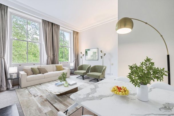 A beautifully presented second-floor apartment set within an elegant period building. - Photo 1