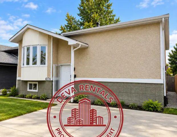 Spacious 4 Bedroom Main Floor Home in Bisset | Open Parking | Private Deck — Spacious 4 Bedroom Main Floor Home in Bisset | Open Parking | Private Deck - Photo 1