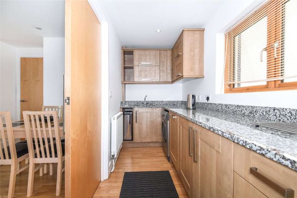 A city centre apartment with balcony and allocated parking for one car. - Photo 1