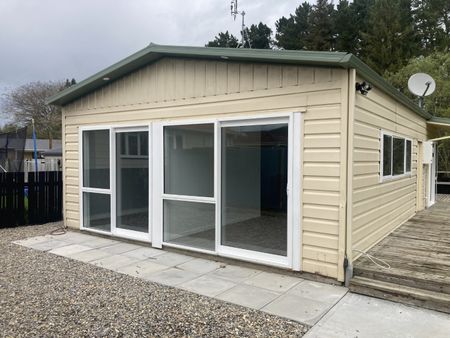 This new, two bedroom home is tucked down a long driveway, surrounded by trees and greenery and offers both a garden shed and a convenient carport. - Photo 2