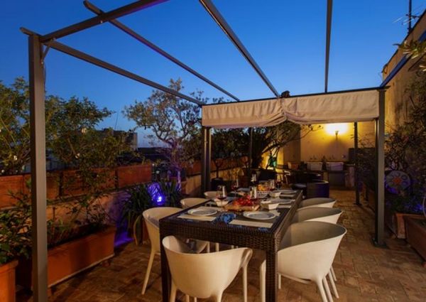 Attic-Monti: Spacious, furnished 3 Bedroom, 2 bath, living room, dining room, study and large panoramic terrace. Bright, silent, located in well kept Palazzo d’Epoca with elevator and doorman. Near transport and Metro.