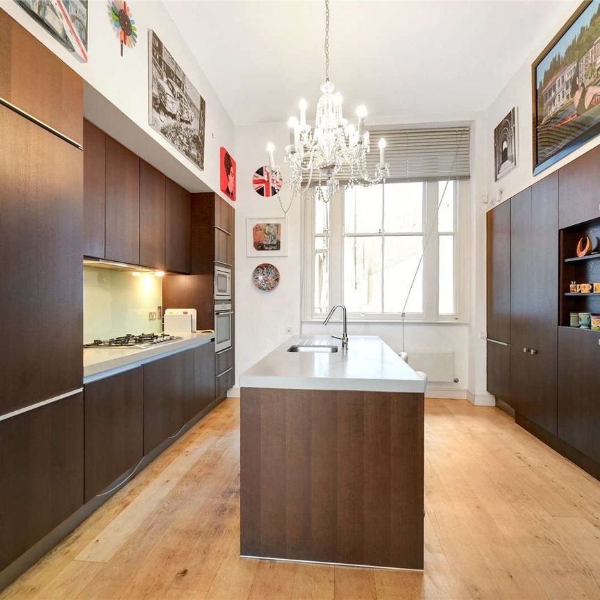 Located in the heart of South Kensington a striking three bedroom period conversion with own entrance, a vast reception room boasting double height ceilings and wooden floors. - Photo 1