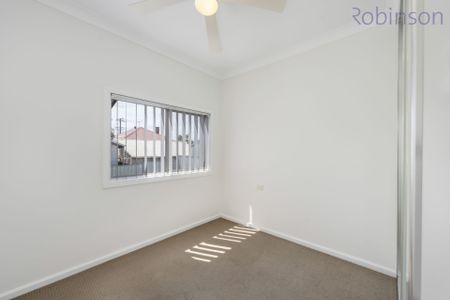 Freshly painted three bedroom home with air-conditioned living space and off street parking. - Photo 2