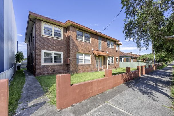 Centrally located large two bedroom unit with sun room. - Photo 1