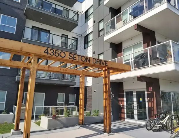 Two bedrooms with large balcony of view in a newer building | 314 - 4350 Seton Dr SE, Calgary - Photo 1