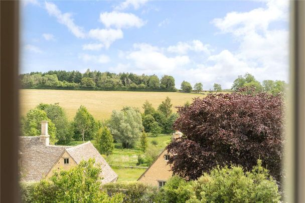 A stunning Grade II-listed barn conversion with beautifully imagined, high specification interiors, in the heart of an idyllic Cotswolds village - Photo 1