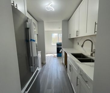 Updated and Bright Corner Unit Two Bedroom in Convenient Lougheed Area - Photo 1