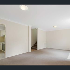 SOUGHT AFTER EAST-SIDE TOWNHOUSE with Brand-New Flooring! - Photo 2