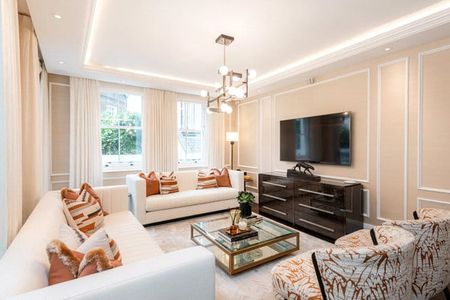 An exceptional three-bedroom, 1,412 sqft apartment arranged across the Ground Floor and Courtyard levels of the building. The apartment entrance features a mirror-fronted storage facility with steps down to the open-plan kitchen and reception space with panel. EPC rating: C. - Photo 4