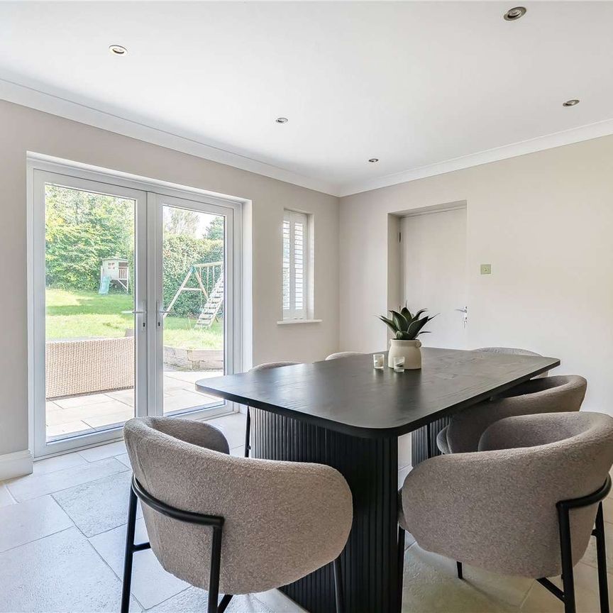 An immaculately presented four-bedroom detached family home with garaging. - Photo 1