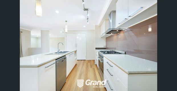 BEAUTIFUL 4 BEDROOM HOME WITH AN ADDITIONAL LARGE LIVING AREA THAT CAN BE USED AS THE 5TH BEDROOM ! - Photo 1