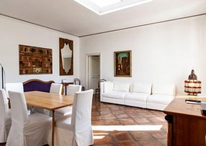 Attic-Monti: 1-6 month rentals. Spacious, furnished 3 Bedroom, 2 bath, living room, dining room, study and large panoramic terrace. Bright, silent, located in well kept Palazzo d’Epoca with elevator and doorman. Near transport and Metro.