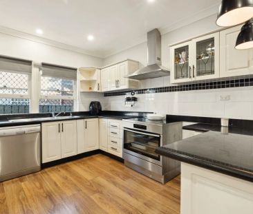 Stylishly updated north-to-rear facing home set on a tree-lined street - Photo 3