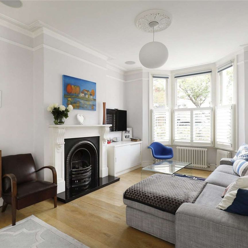 Neutrally decorated four bedroom family house with wooden floors on this quiet street in Parsons Green. - Photo 1